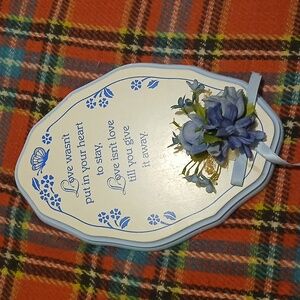 Decorative wooden plaque with love quote and blue flowers